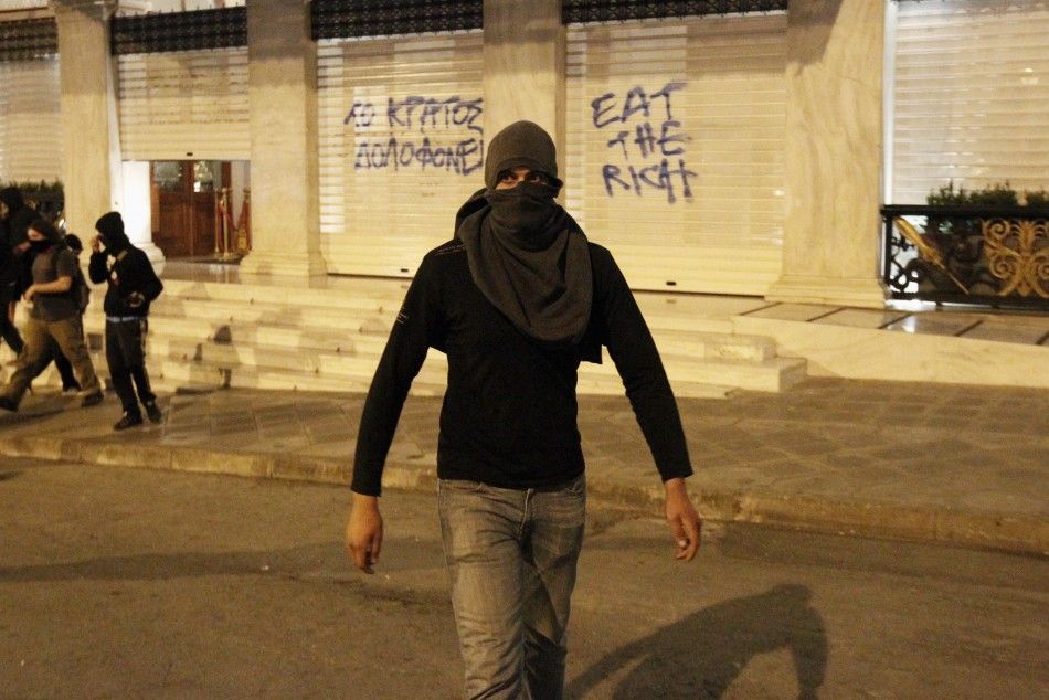  A protester walks away from the entrance of Grande Bretagne hotel during riots at central Syntagma square in Athens