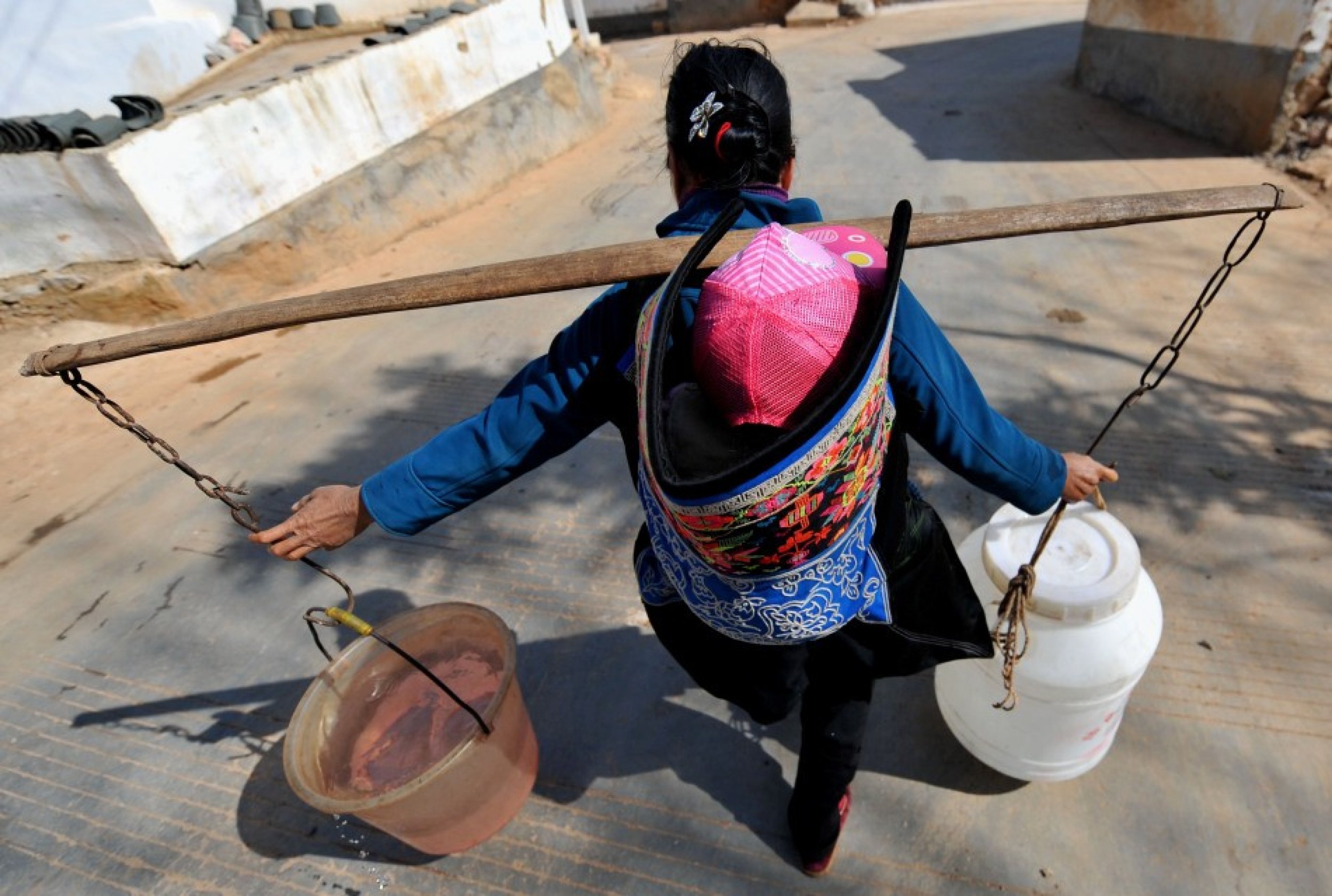 A Woman Carries Water Home