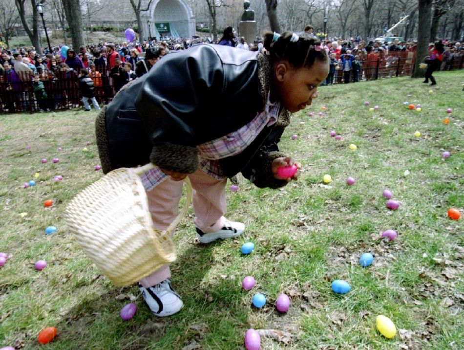 Keesha Watson of Manhattan collects easter eggs in New Yorks Central Park, April 6, during the egg hunt at the 50th annual quotEggstavaganzaquot pre-Easter family celebration. 