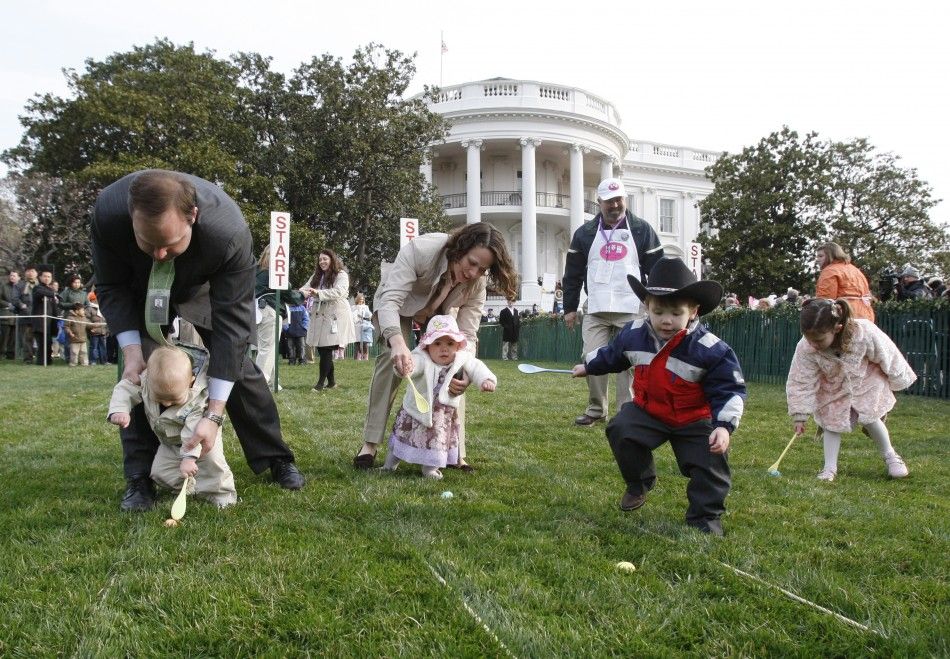 Children, with the help of their parents, take part in the annual Easter Egg Roll on the South Lawn of the White House in Washington, March 24, 2008. 