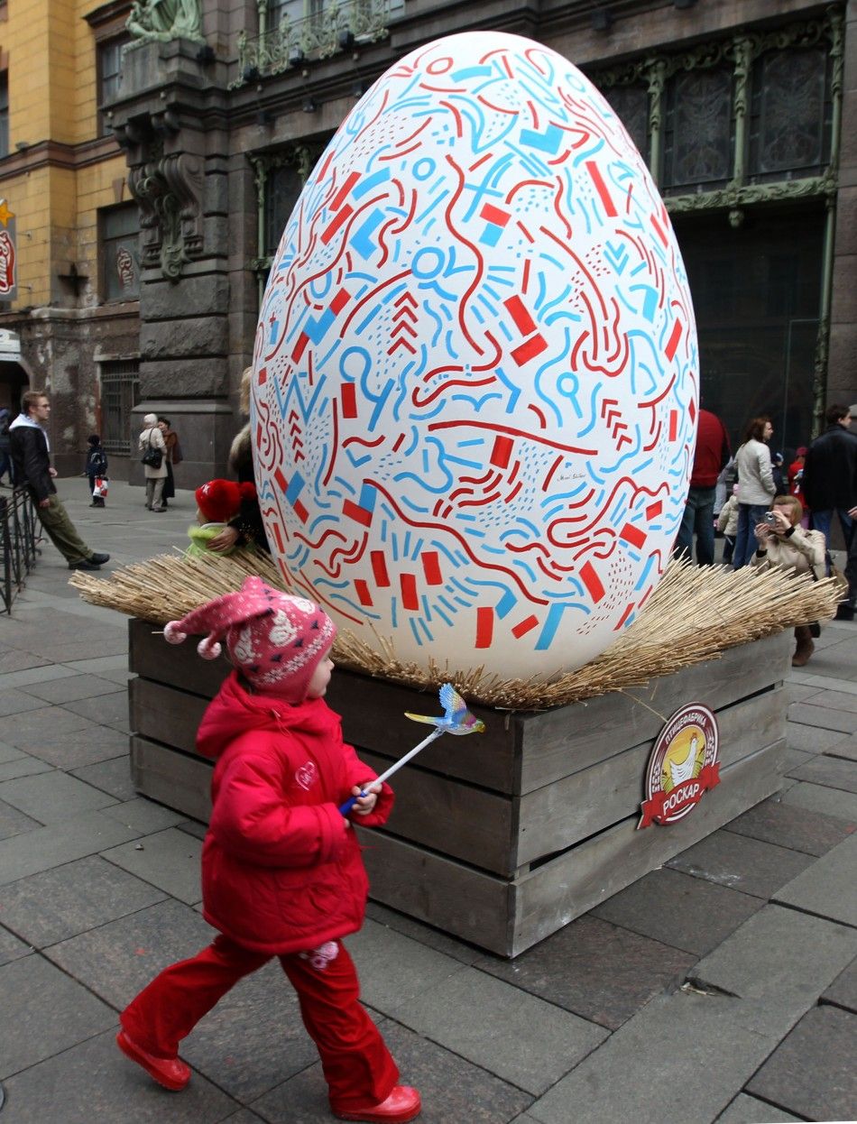 A child passes by a 3 metre 9.84 feet high Easter egg coloured by local artists on Easter Sunday in central St.Petersburg April 4, 2010. 