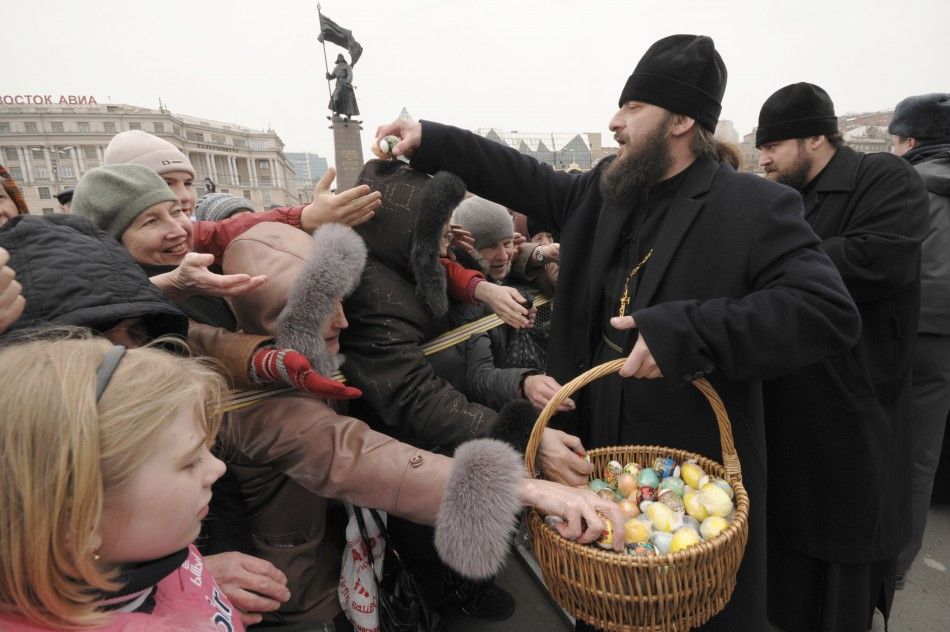 Orthodox priests distribute Easter eggs in the central square of Russias far eastern city of Vladivostok during the celebration of the Easter April 4, 2010.