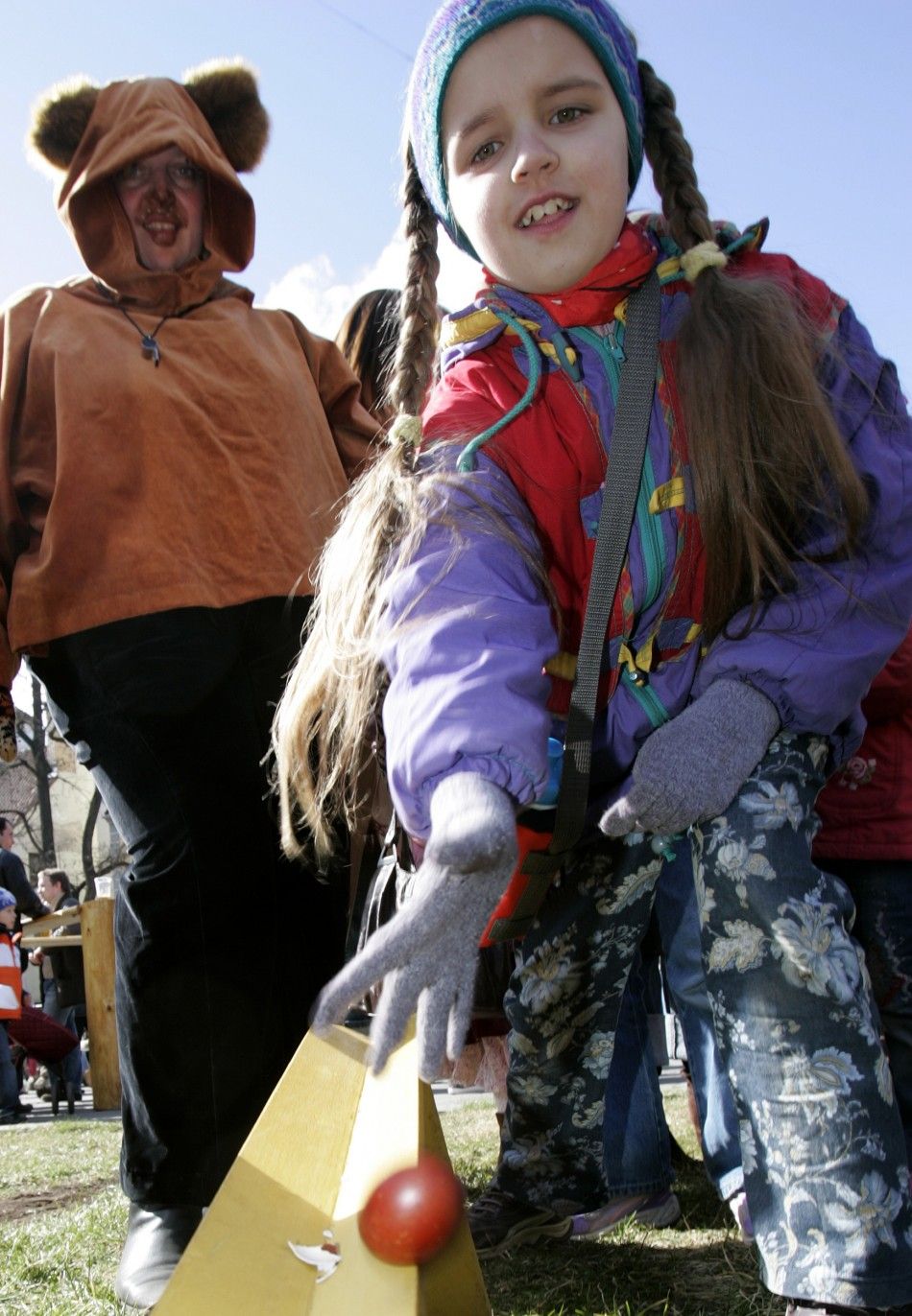 A girl rolls a boiled egg during traditional Easter festivities in the old city of Riga April 8, 2007. 