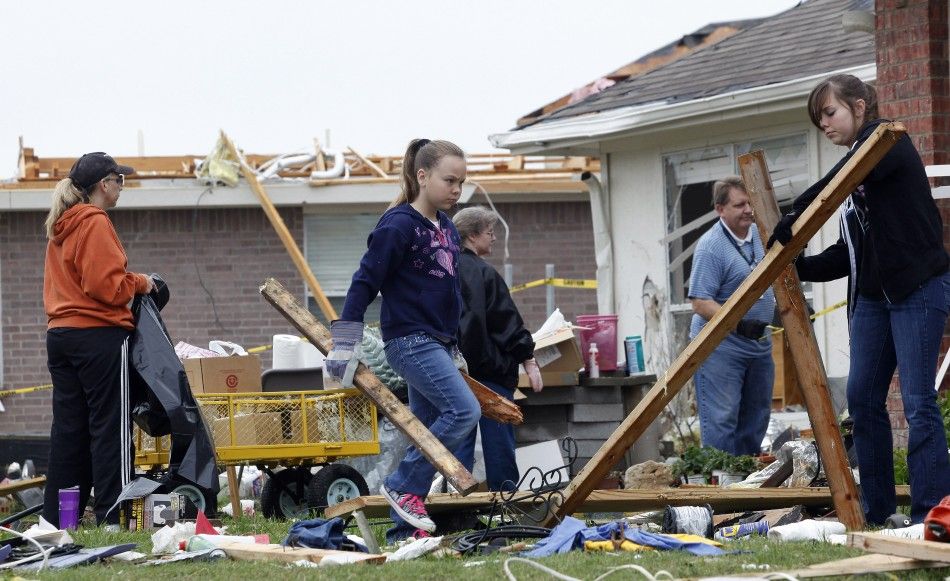 Abbey Wheeler carries debris from the remains of the familys home during the cleanup effort in Forney