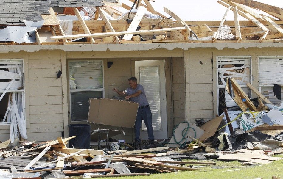 Billy Ballard removes debris from his home during the cleanup effort in Forney