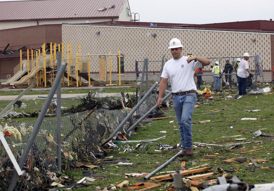 Cody Tapor walks through the debris at Crosby Elementary School during the cleanup effort in Forney