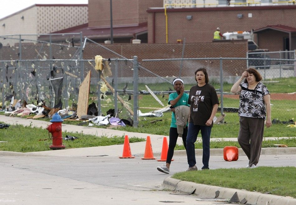 Local volunteers walk by Crosby Elementary School during the cleanup effort in Forney