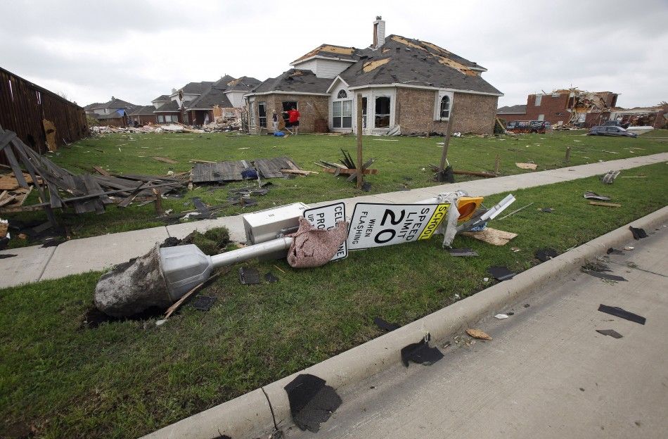 A traffic sign lays on its side after being uprooted by the storm in Forney