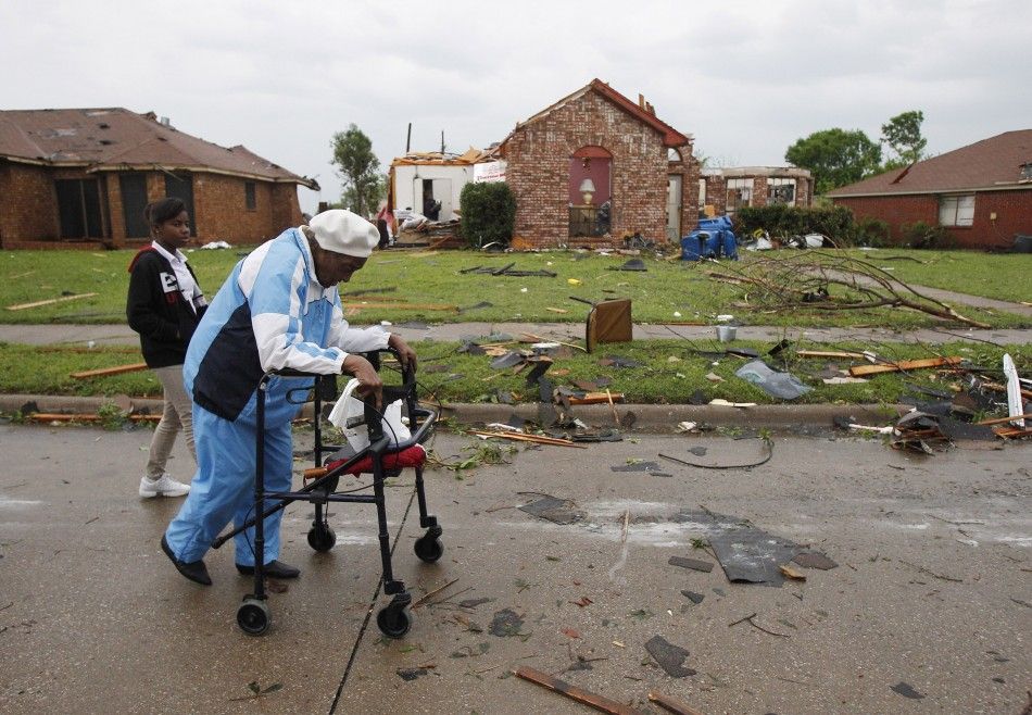 Chandler makes her way out of her neighborhood after a tornado destroyed her home in the Dallas suburb of Lancaster