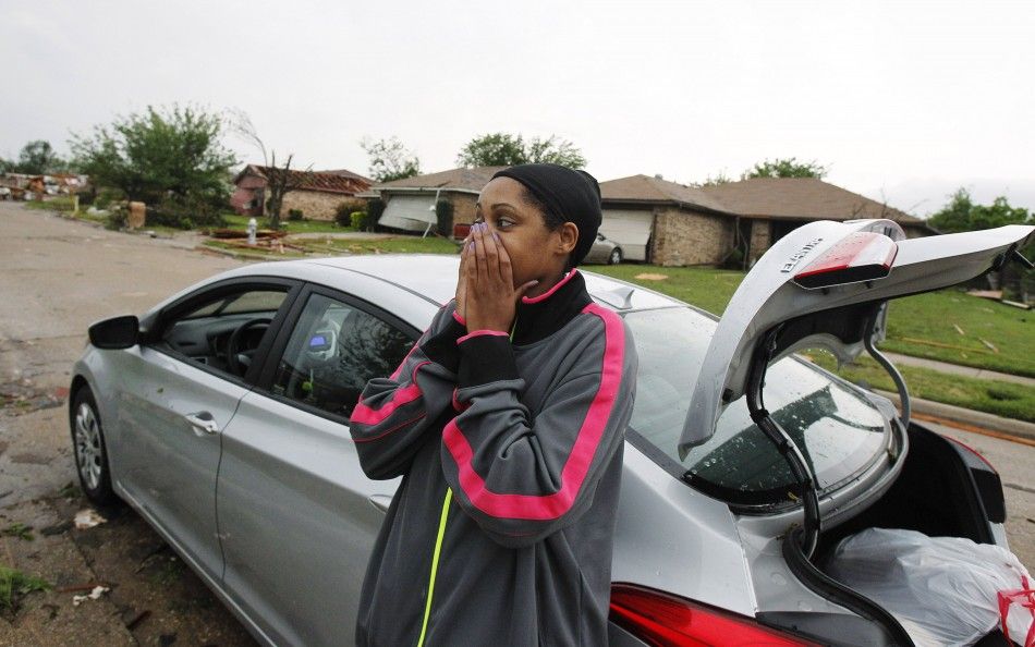 Menique Waites looks at her home which was destroyed by a tornado that ripped through the Dallas suburb of Lancaster