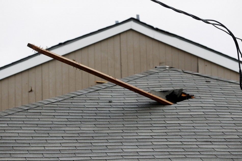 A pole is seen protruding through a roof after a series of tornadoes ripped through the Dallas suburb of Lancaster