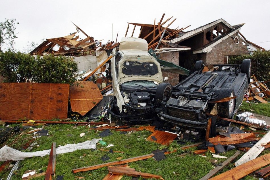 Damaged cars are seen amid the debris after a tornado struck a residential neighborhood in Lancaster