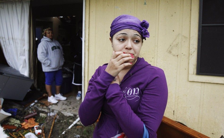 A resident looks at the damage caused by a tornado that ripped through the Dallas suburb of Lancaster