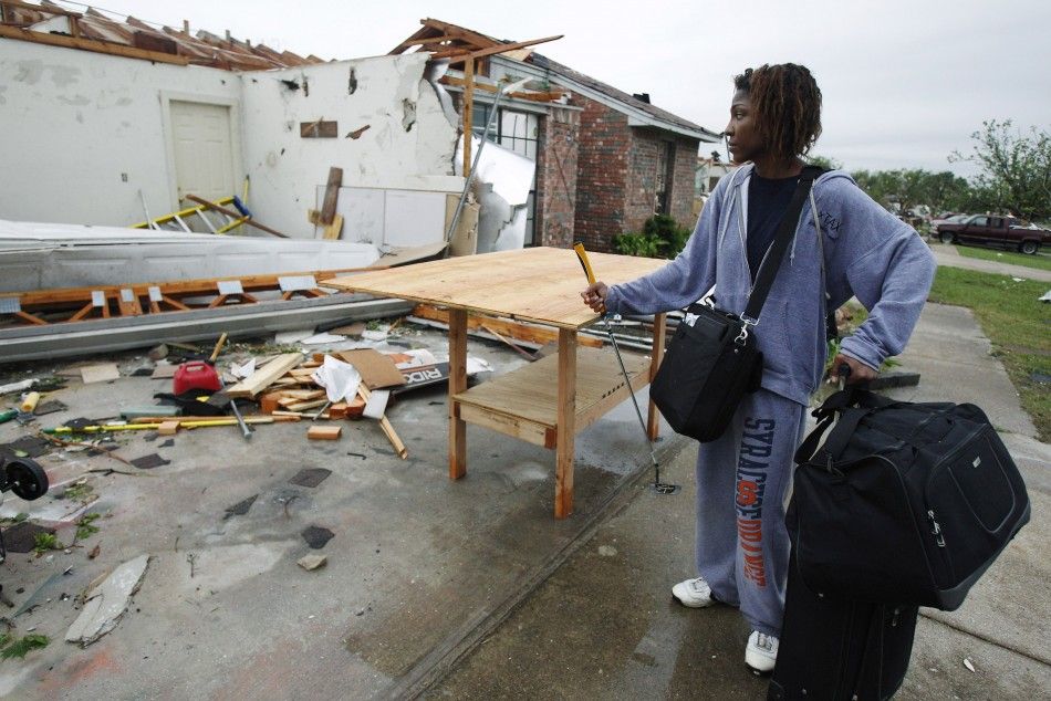 Britteny Bradford looks at her home which was destroyed by a tornado that ripped through the Dallas suburb of Lancaster