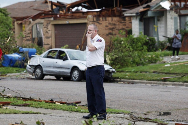 A rescue worker surveys the damage after a series of tornadoes ripped through the Dallas suburb of Lancaster
