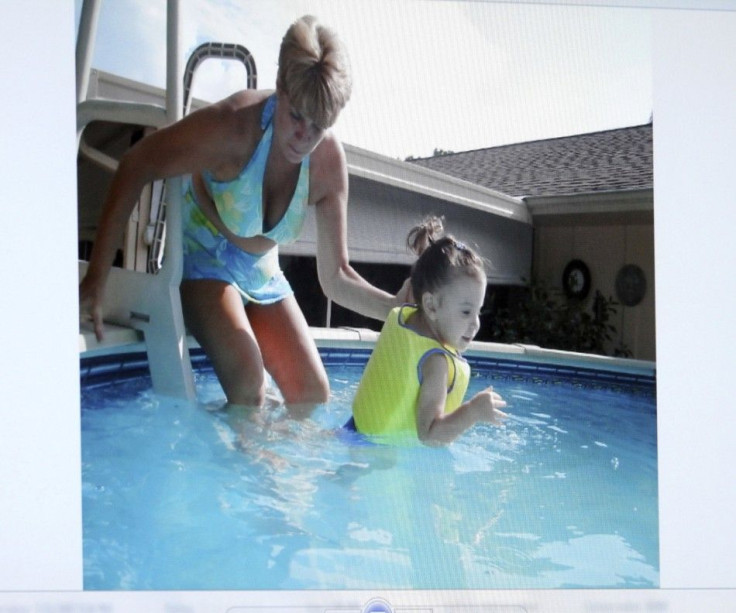 An image projected on a courtroom monitor shows Cindy Anthony (L) with her granddaughter Caylee, in a swimming pool which was submitted as evidence in the Casey Anthony trial at the Orange County Courthouse in Orlando, Florida June 24, 2011.