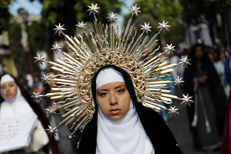 A penitent, dressed as the Virgin Mary, participates in a re-enactment of the crucifixion of Jesus Christ on Good Friday in Iztapalapa in Mexico City April 6, 2012. 