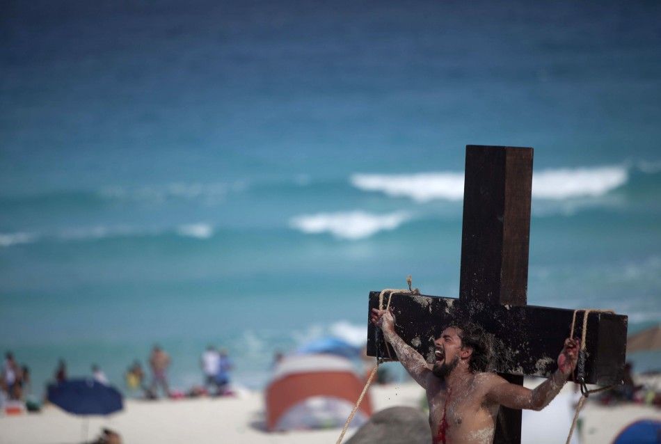 An actor representing Jesus Christ participates in a re-enactment of the crucifixion of Jesus Christ on Playa Delfines Dolphin Beach on Good Friday in Cancun April 6, 2012.