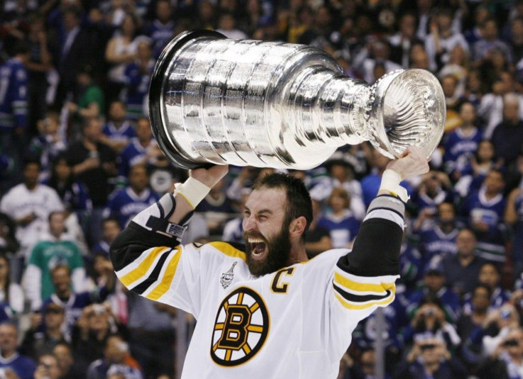 Bruins captain Zedno Chara celebrates with the Stanley Cup.