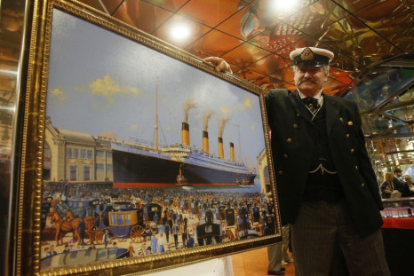 Maritime artist Flood of Del Ray Beach, Florida poses with his painting of the doomed Titanic liner on board the Titanic Memorial Cruise off Cobh