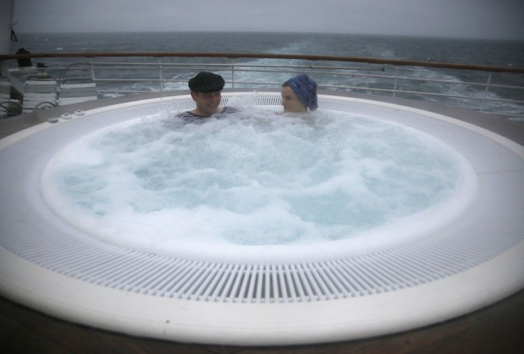 Norwegians sit in a hot tub on the Titanic Memorial Cruise as it moves through high winds off Cobh