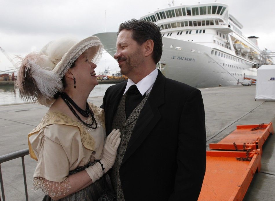 Newlyweds pose while wearing period costume before boarding the Titanic Memorial Cruise in Southampton, England