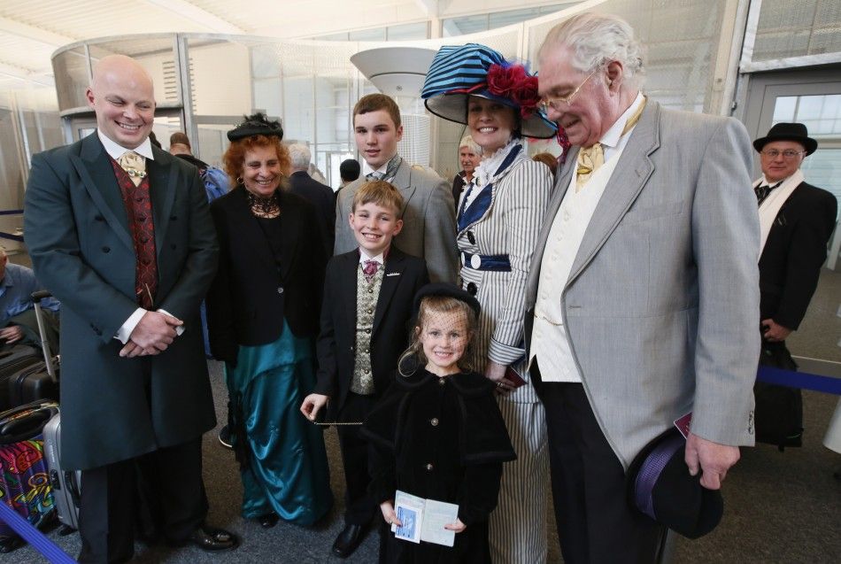 Three generations of the Free family wear period costumes as they queue to board the Titanic Memorial Cruise in Southampton