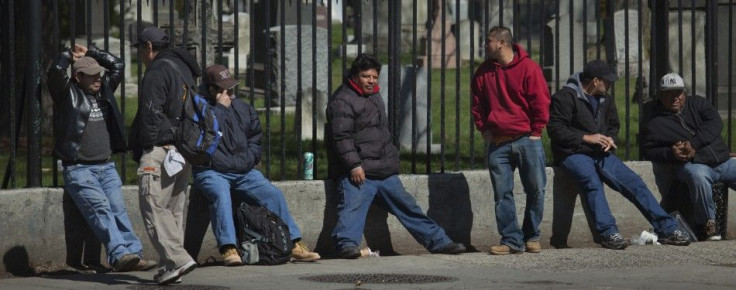 Men looking for labor jobs stand along a street in Brooklyn, New York