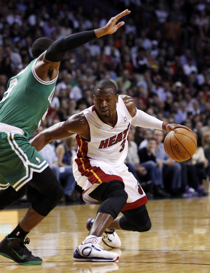 Dwayne Wade looks for an opening against Rajon Rondo.