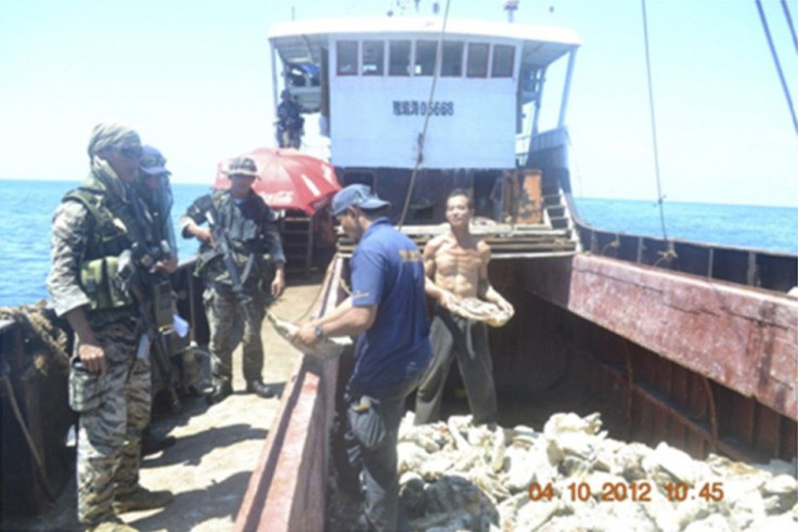 Members of Philippine Army inspect one of eight Chinese fishing boats spotted in Scarborough Shoal in the South China Sea.