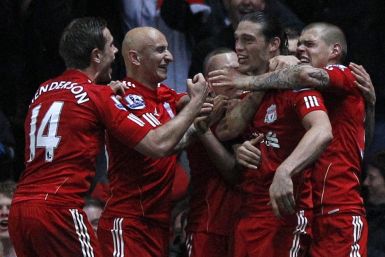 Liverpool&#039;s Andy Carroll is mobbed by his teammates after scoring the winning goal against Blackburn.