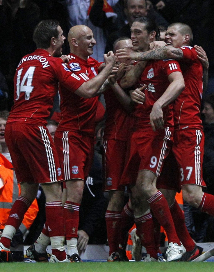 Liverpool&#039;s Andy Carroll is mobbed by his teammates after scoring the winning goal against Blackburn.