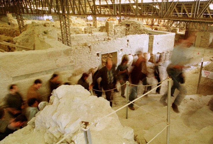 A group of journalists leave the archaeological site of prehistoric city of Akrotiri at the volcanic cycladic island of Santorini