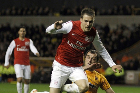 Arsenal&#039;s Aaron Ramsey jumps a tackle during their win over Wolves.