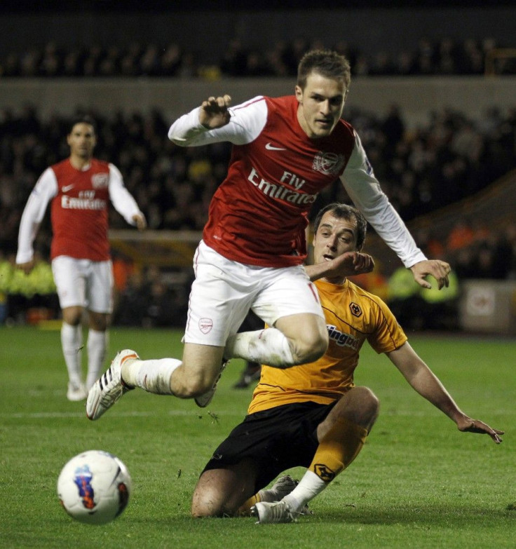 Arsenal&#039;s Aaron Ramsey jumps a tackle during their win over Wolves.