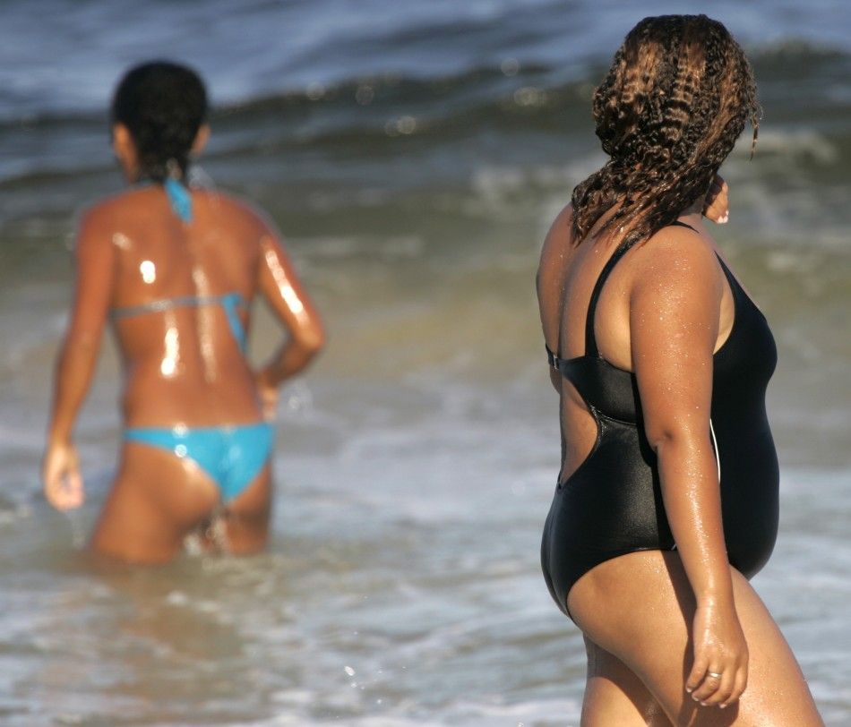 An overweight Brazilian woman walks on Copacabana beach in Rio de Janeiro,