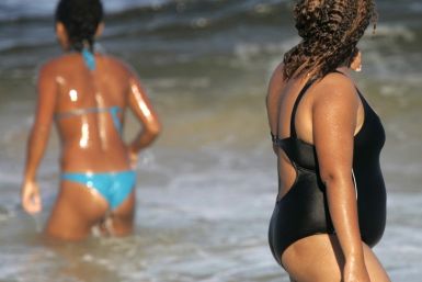 An overweight Brazilian woman walks on Copacabana beach in Rio de Janeiro,