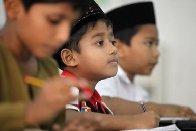 Young Myanmar refugees from the Rohingya ethnic minority attend their English class in Kuala Lumpur
