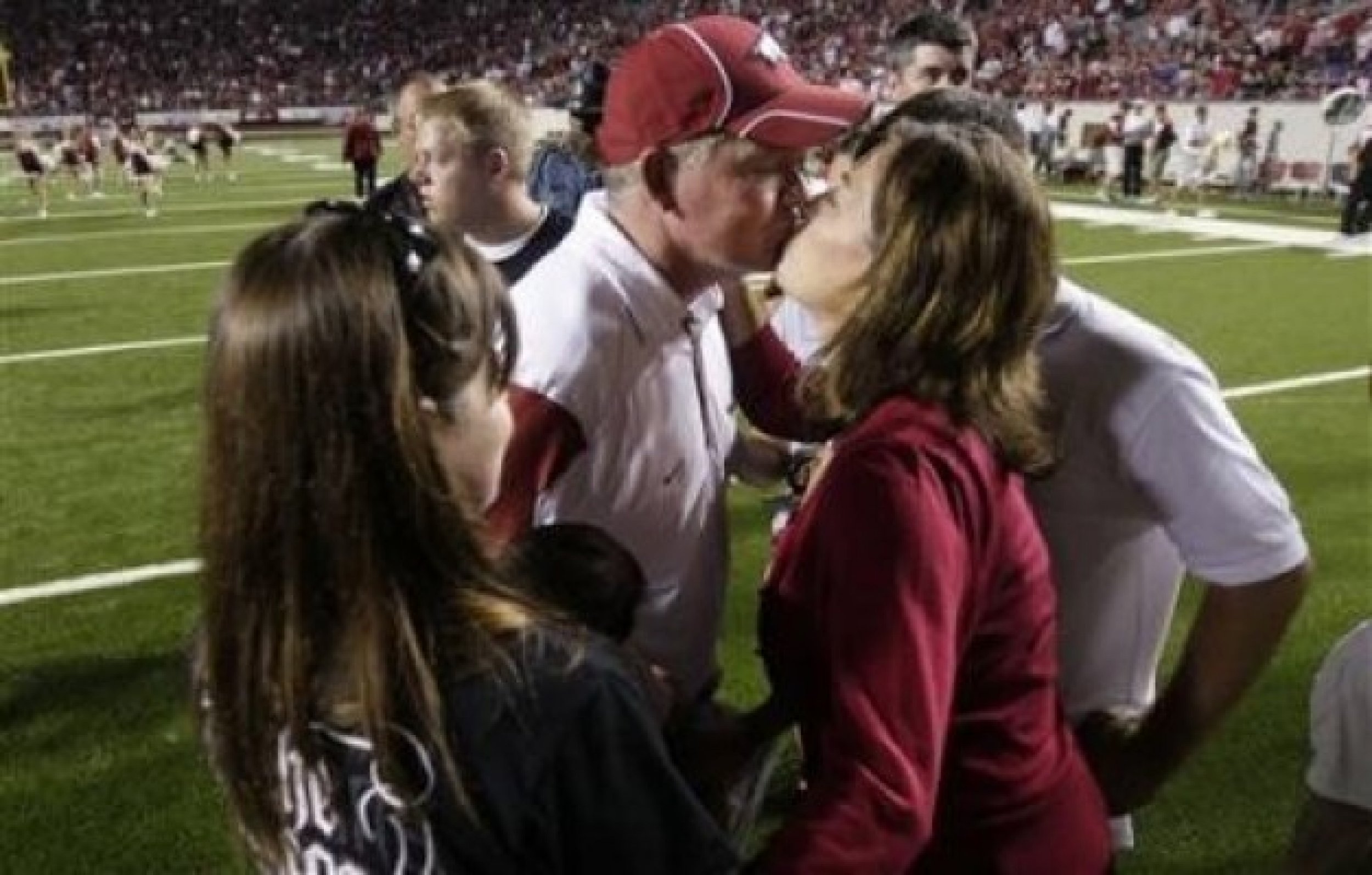 Bobby Petrino and his wife kiss after a game