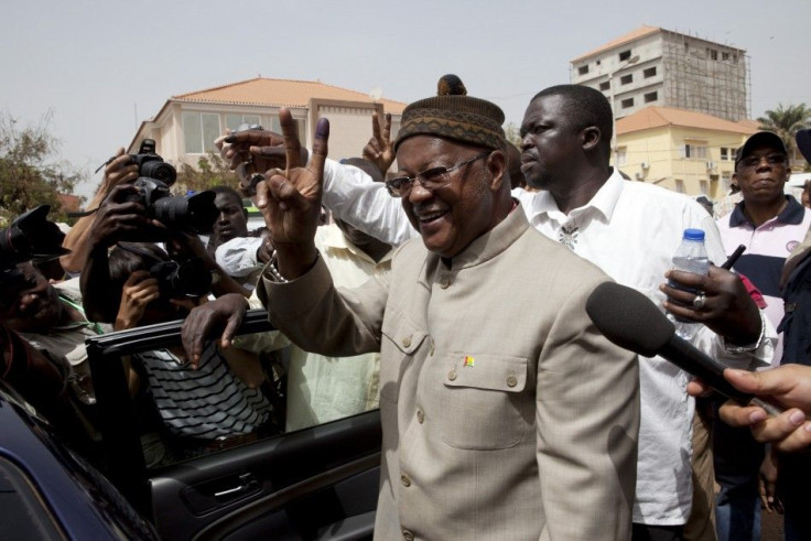 Guinea-Bissau ruling party presidential candidate Gomes Junior holds up his inked finger after voting in the capital Bissau.