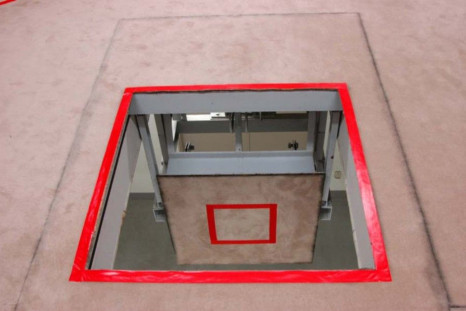 A trap door marked with a red square where an inmate stands, is seen opened at an execution chamber at the Tokyo Detention Center.