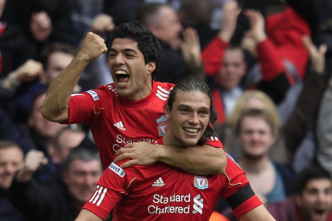 Liverpool&#039;s Luiz Suarez and Andy Carroll celebrate after downing Everton 2-1.
