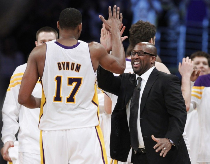 Mike Brown high-fives Andrew Bynum as he comes off the court. Their relationship has been rocky so far this season.