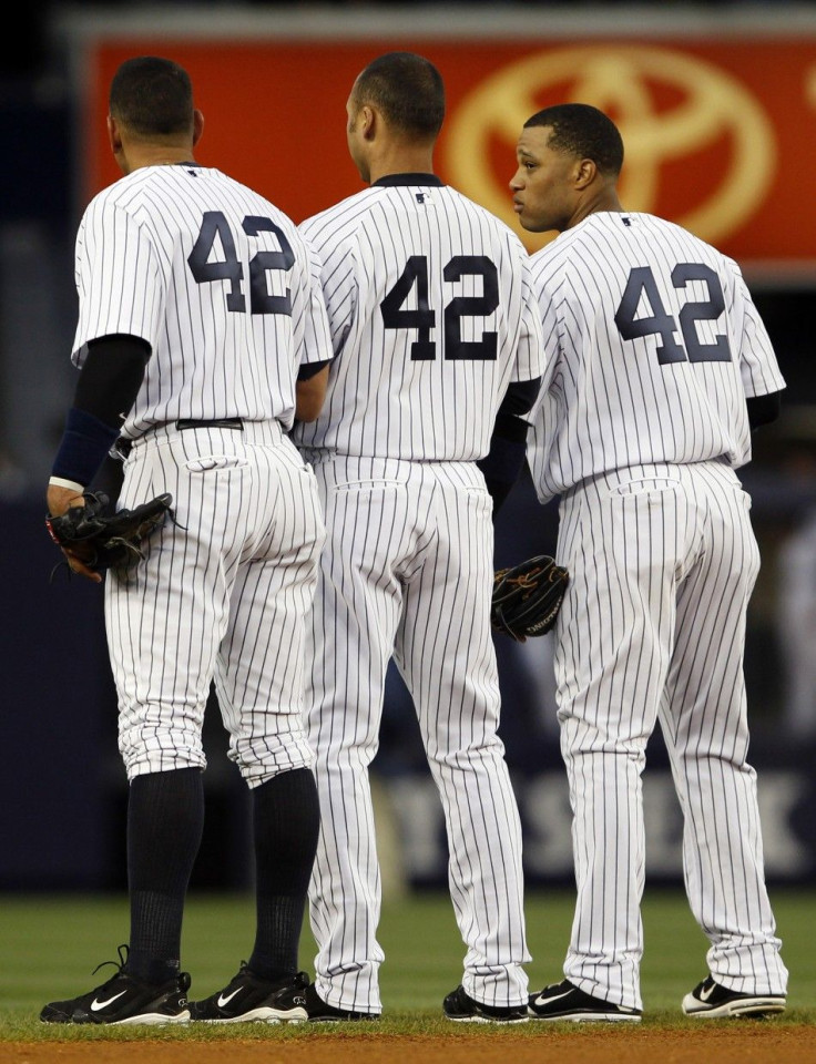 Alex Rodriguez, Derek Jeter and Robinson Cano wear Jackie Robinson's number before a game.