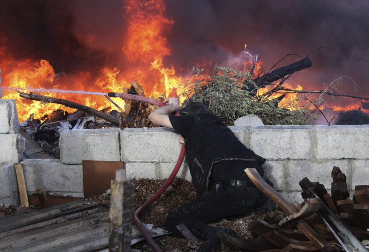 Syrian man tries to put out fire in Jobar, Damascus