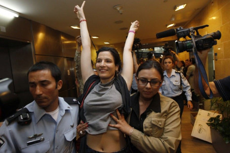 Israeli police escort a pro-Palestinian Israeli activist at Ben Gurion International Airport
