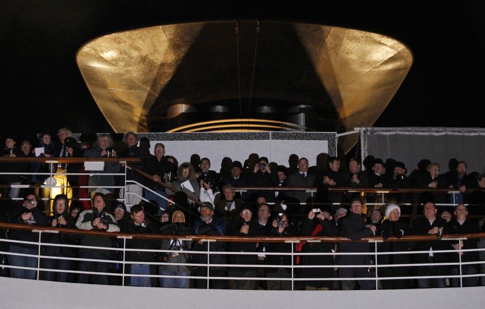Passengers take part in service of remembrance aboard the Titanic Memorial Cruise in the western Atlantic Ocean