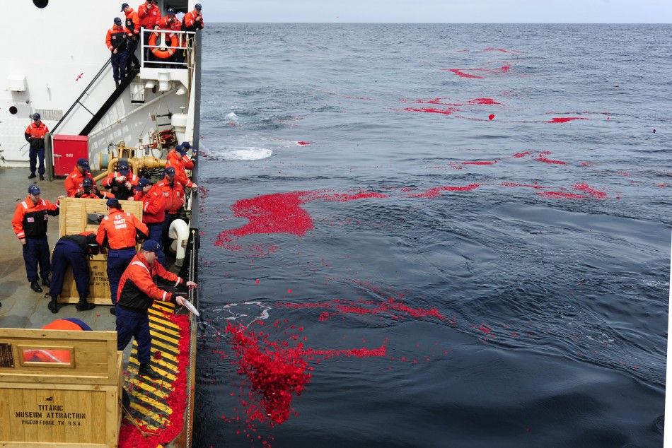 U.S. Coast Guard Cutter Juniper crew members lay 1.5 million dried rose petals over the RMS Titanics resting site in the north Atlantic Ocean