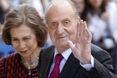 Spain&#039;s King Juan Carlos waves beside Queen Sofia