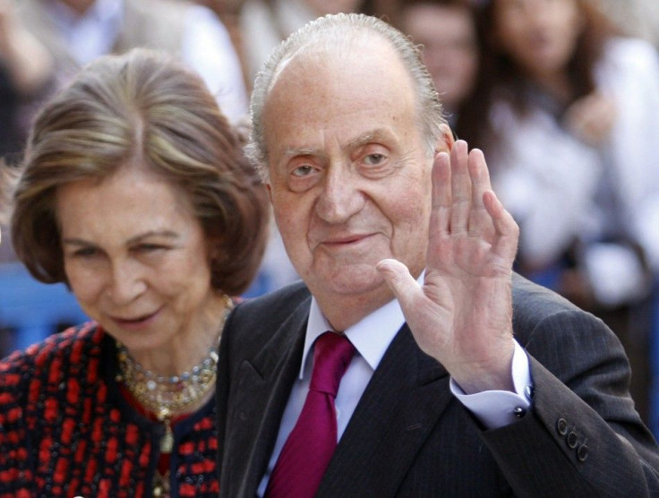 Spain&#039;s King Juan Carlos waves beside Queen Sofia